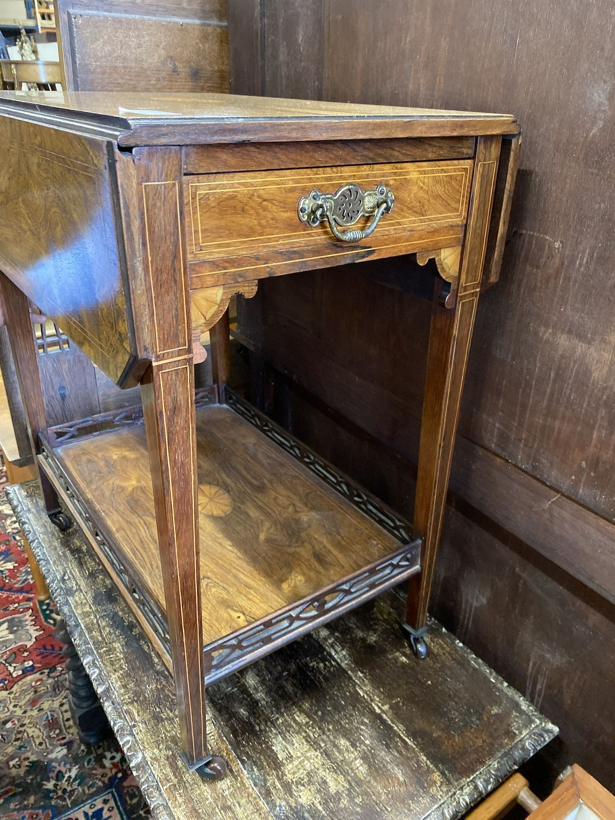 An Edwardian satinwood inlaid rosewood drop flap two tier table, width 60cm, depth 40cm, height 69cm